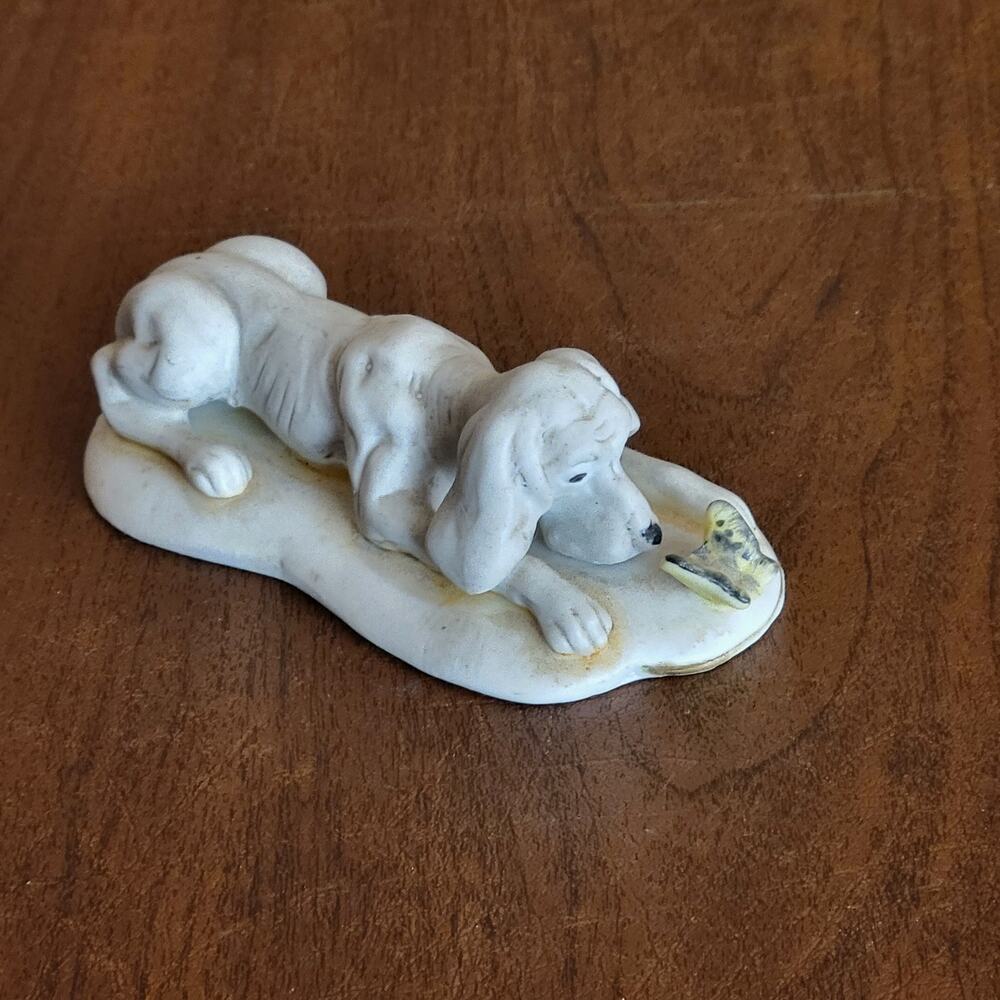 Vintage parian porcelain dog figurine spaniel laying down with a butterfly